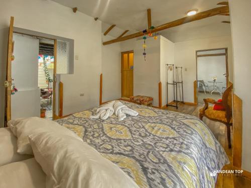 a bedroom with a bed with towels on it at The Andean Rooftop guesthouse in Cusco