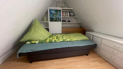 a small bedroom with a bed with pillows on it at Apartment über 2 Etagen nahe Messe und Stadion in Dortmund