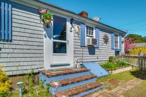 a house with a white door and a brick stairs at Less Than 1 Mi to Sea Street Beach Dennis Port Home! in Dennis Port