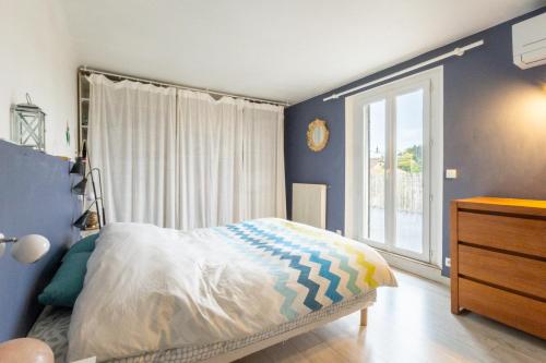 une chambre avec un lit et une grande fenêtre dans l'établissement Le Duplex des Terrasses, à Marseille