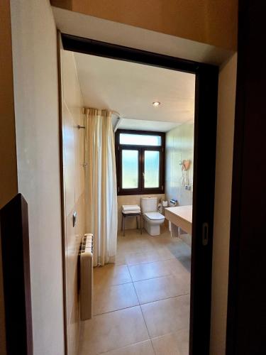 a bathroom with a toilet and a sink at Apartamentos Rurales L'Arquera in Llanes