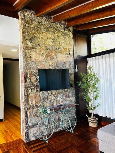 a stone wall with a flat screen tv on it at Apartamentos Rurales L'Arquera in Llanes