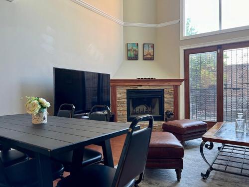 a living room with a table and a fireplace at 4 bedroom in Best Location Parking Fireplace Back Yard Home office Pets Welcome in Chicago