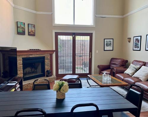 a living room with a table and a fireplace at 4 bedroom in Best Location Parking Fireplace Back Yard Home office Pets Welcome in Chicago