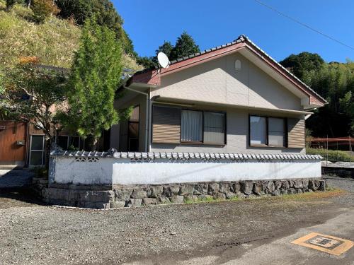 a house with a stone retaining wall at Shimanto - House - Vacation STAY 16735 in Shimanto