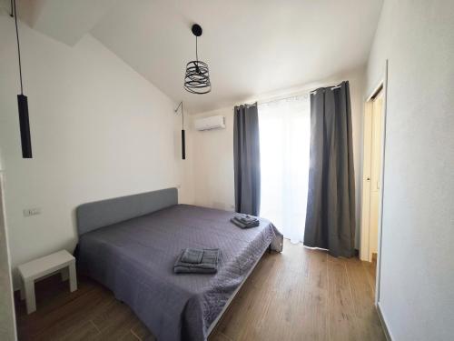 a small bedroom with a bed and a window at Suite IKEBANA Porto Pino in Porto Pino