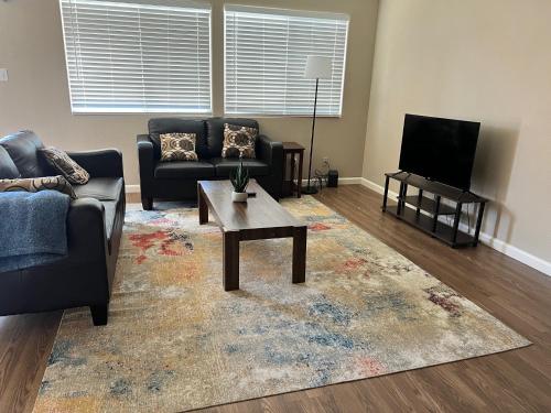 a living room with a couch and a tv at Serene 2bed 1bath condo with parking in Fresno