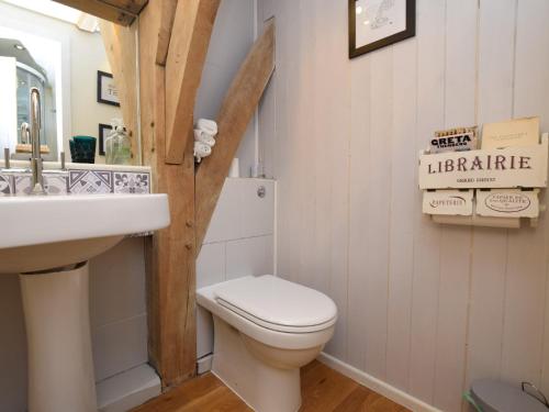 a bathroom with a white toilet and a sink at 1 Bed in Biggar 75414 in Biggar