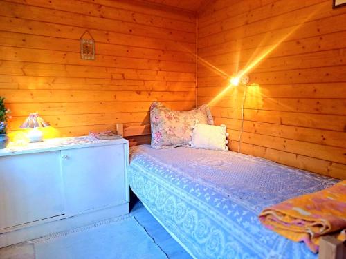 a bedroom with a bed in a wooden room at Lootuse Spa in Nõmmemaa