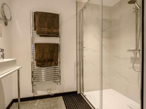 a bathroom with a shower with a glass door at 1 Bed in Waterfall 89733 in Waterhouses