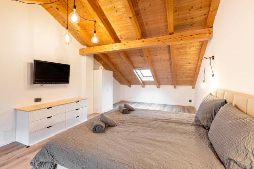 a bedroom with a large bed with a tv on the wall at Jägerlodge Apartments in Ladis