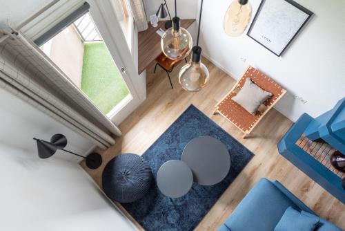an overhead view of a living room with a table and chairs at Best Western Bridge Hotel Lyon East in Jons