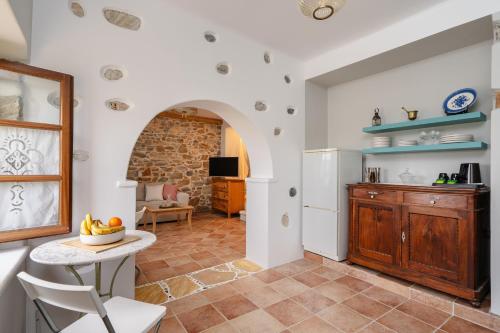 a kitchen with a table and a refrigerator at Feel Filoti in Philotium