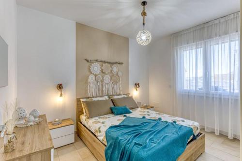 a bedroom with a large bed with blue sheets at Casa Dandari in Torre San Giovanni Ugento