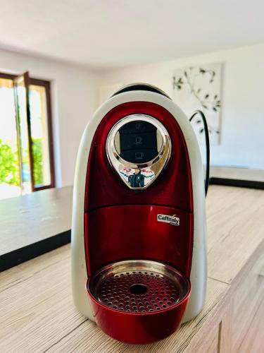 a red and white toaster sitting on a wooden floor at Paradise by the Lake Lugano in Brusino Arsizio