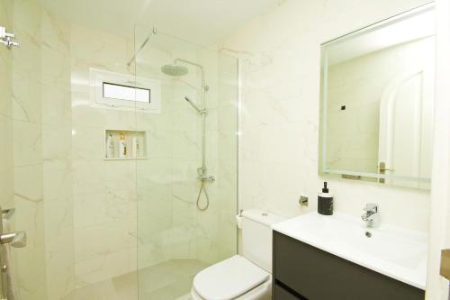 a bathroom with a shower and a toilet and a sink at Casa Federico in Puerto del Carmen
