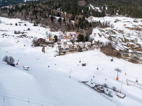 a group of people skiing down a snow covered slope at Jägerlodge Apartments in Ladis