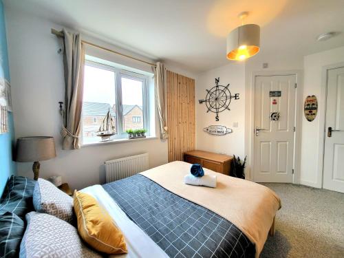 a bedroom with a large bed and a window at Seaside beach themed home with garden and driveway in Lytham St Annes
