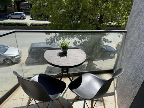 Paradiso Apartments في أوخريد: طاولة مع كرسيين ونصب الفخار على الشرفة