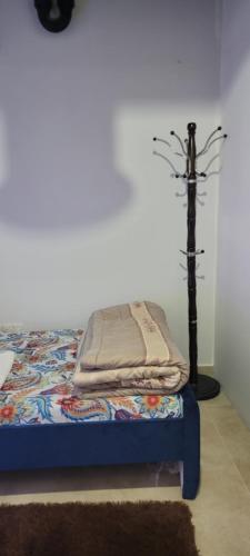 a bed with a quilt on it in a room at Home Away Apartment in Abu Dhabi