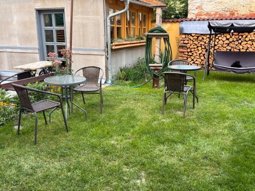 a group of tables and chairs in a yard at Penzion U Báby in Třeboň