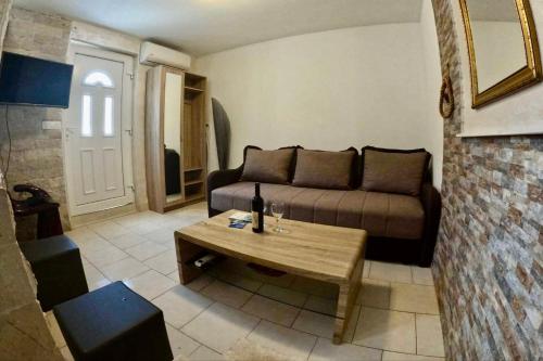 a living room with a couch and a coffee table at Apartments Obradovic in Krasici