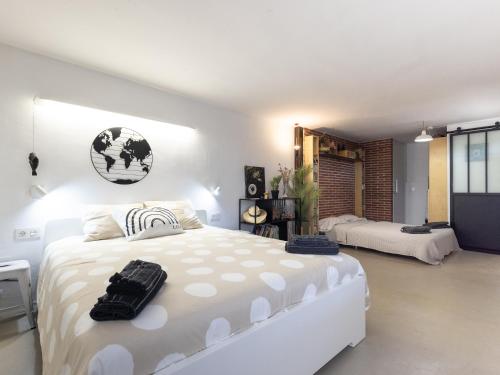 a white bedroom with a large white bed in it at CHEZ ADELA in Almoster