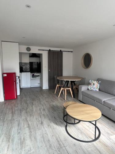 un salon avec un canapé et une table dans l'établissement Maison neuve Pantin à 5 min de Paris, 2 chambres et 1 canapé-lit, à Pantin