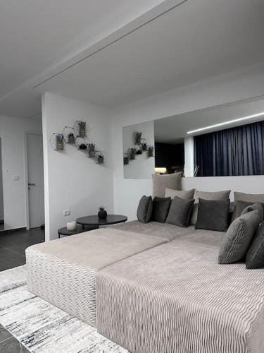a white bedroom with a large bed in a room at Lumi Residence Apartment 2 in Sarandë