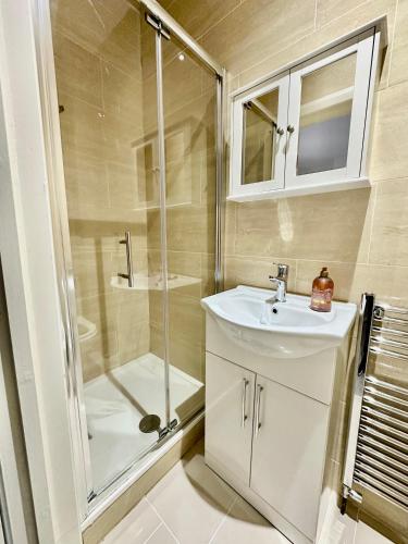a bathroom with a sink and a shower at Westferry in London