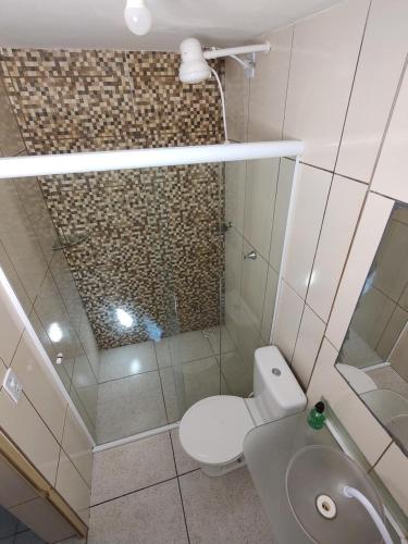 a small bathroom with a toilet and a sink at Abaré Slim Suítes in São Miguel dos Milagres