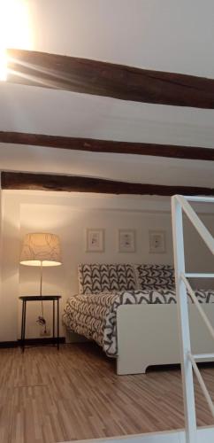 a bedroom with a bed and a wooden floor at Akihome Portanova in Naples