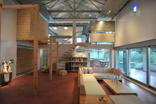 a living room with a couch and a spiral staircase at The Architect's House in Neo Chorio in Néon Khoríon