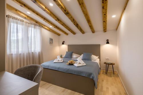a bedroom with a bed with two stuffed animals on it at Villa Oasis in Kastel Novi