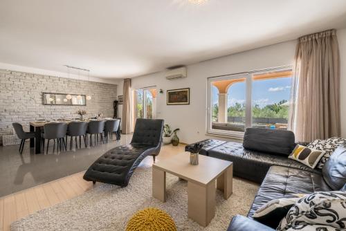 a living room with a couch and a table at Villa Oasis in Kastel Novi