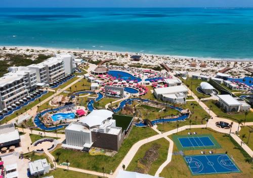 an aerial view of a water park next to the ocean at Planet Hollywood Cancun by Royalton, An Autograph Collection All-Inclusive Resort in Cancún