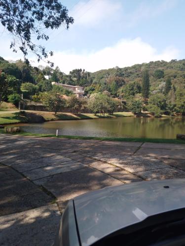 a car parked next to a lake with a view at Chale em Atibaia in Atibaia