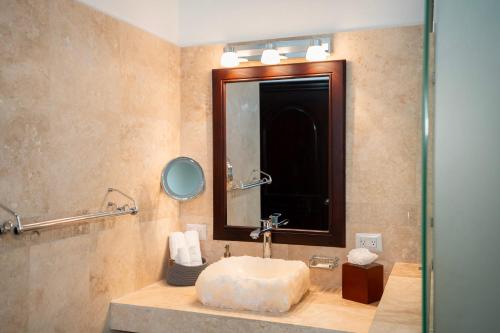 a bathroom with a sink and a mirror at Paradise Hot Springs - Thermal Water & Volcano Views in Fortuna