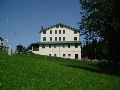 a large white building on top of a green field at Normena Mountain Residence in Tizzano Val Parma