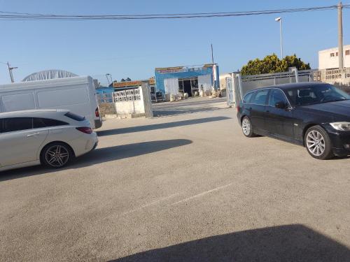 two cars are parked in a parking lot at Carpe Diem da Salvina in Pachino
