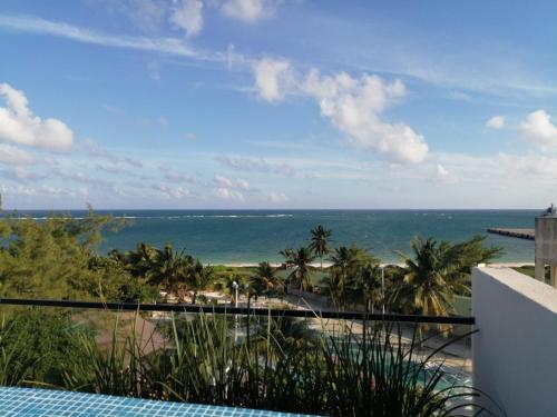 a view of the ocean from the balcony of a resort at Modern 1 bedroom suite by beach Great location! in Puerto Morelos