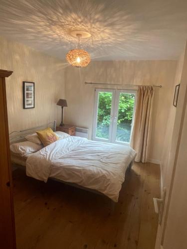 a bedroom with a white bed and a window at charme de la campagne in Prelauff
