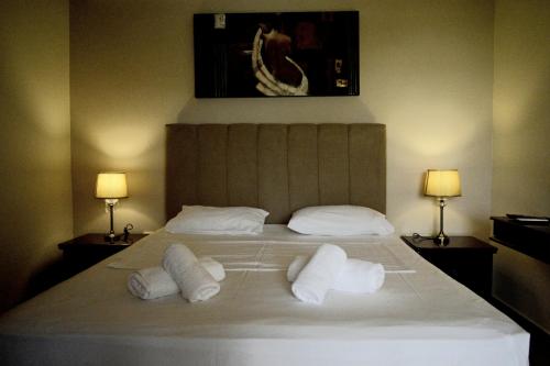 a bedroom with a large bed with two pillows at Malvazios Villas #8 in Gythio