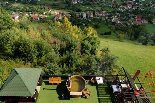 an overhead view of a house with benches and trees at Popasul de Wis in Moieciu de Jos