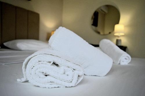 a pile of towels sitting on top of a bed at Malvazios Villas #8 in Gythio