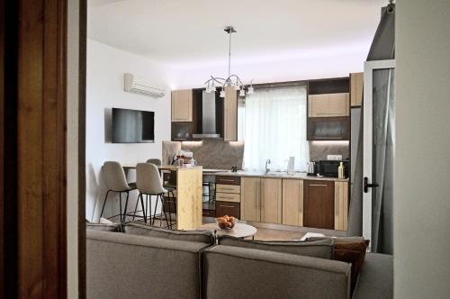 a kitchen with a couch and a table in it at Malvazios Villas #8 in Gythio