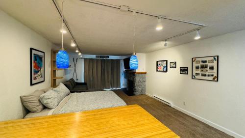 a living room with a bed and a couch at Cute Ski Condo at Base of Mt Alyeska Prime Location in Anchorage