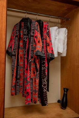 a group of shirts hanging on a rack at The Mbuya Residence in Kampala