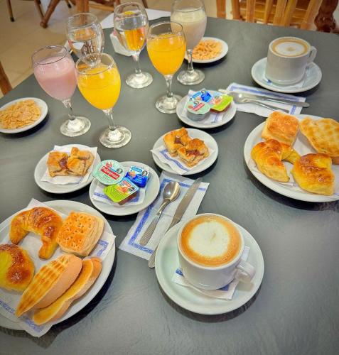 una mesa con platos de comida y una taza de café en Intersur Independencia, en Termas de Río Hondo