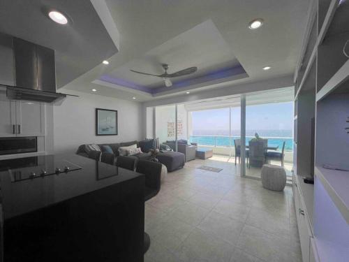 a living room with a couch and a table at Bueno Paradise Condo In Marbella in Juan Dolio